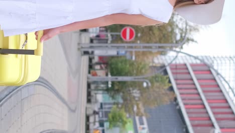 woman in Casual Clothes and White Hat Holding Passport with Tickets and Red Suitcase Woman in Casual Clothes and White Hat Holding Passport with Tickets and Red Suitcase Isolated on Blue Background Passenger Travel Abroad Weekend Getaway Air Flight Journey Concept