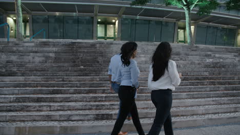 three young business people returning from their break and going upstairs