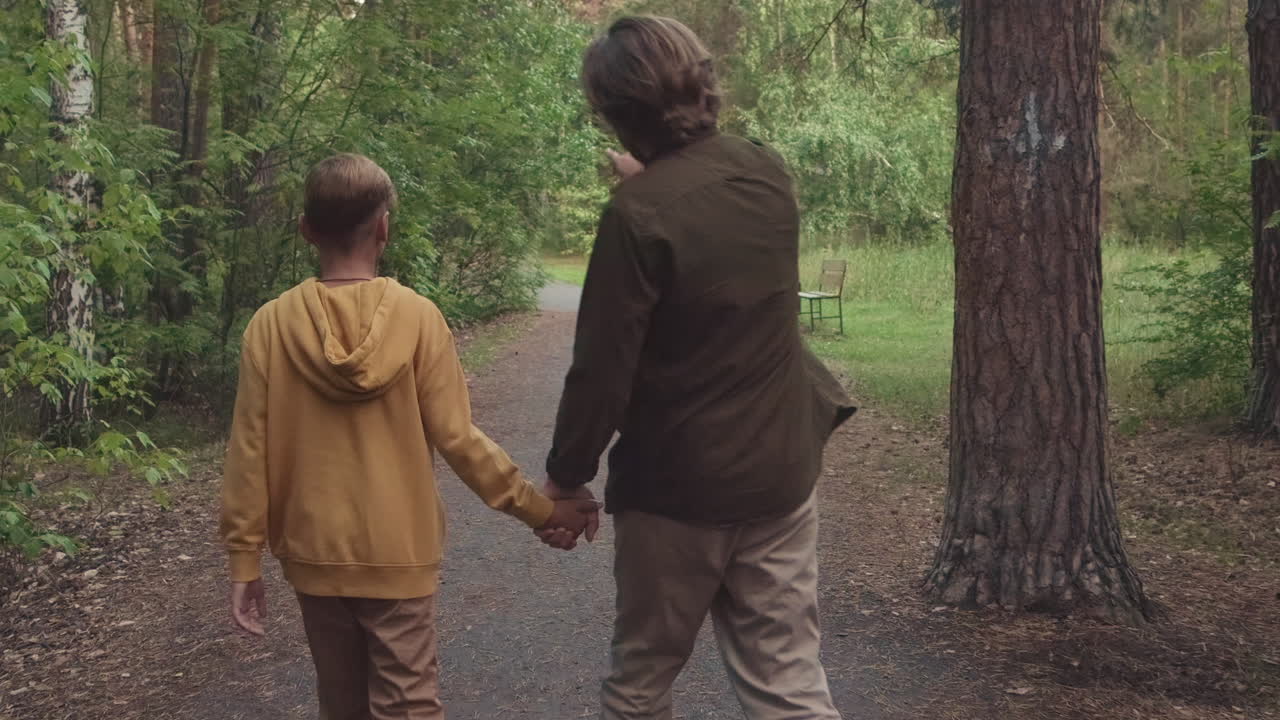 Dad And Son Walking In Forest