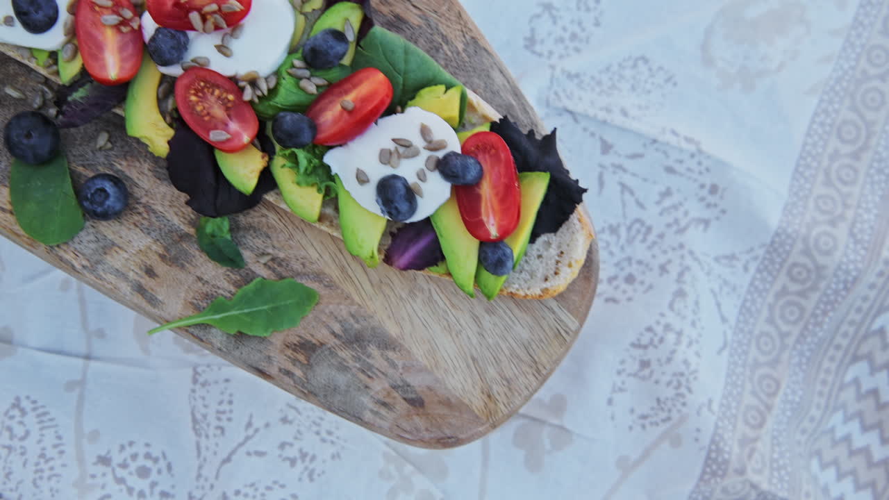 A delicious healthy vegetable platter for a good, healthy meal of avocado and tomatoes baguette sandwich - close up