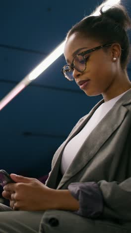 woman using smartphone in a modern setting