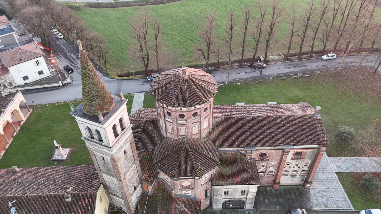 Sanctuary of the Blessed Virgin of Mercy and a church with a bell tower under soft sunset light, surrounded by agricultural fields and the Po Valley landscape near Castelleone, Lombardy, Italy