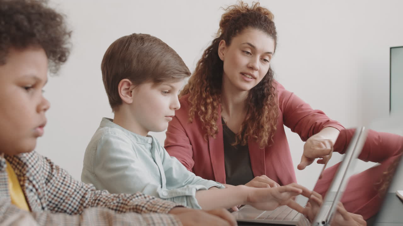 Teacher Helping Boy on IT Lesson