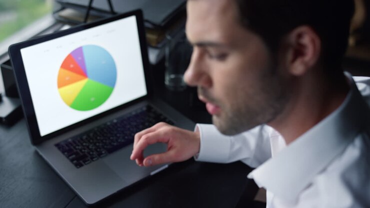 Freelancer pointing at graphs on screen