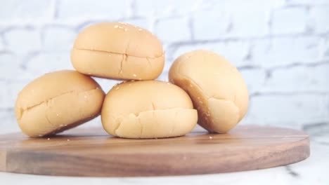 stacked burger buns on wooden board