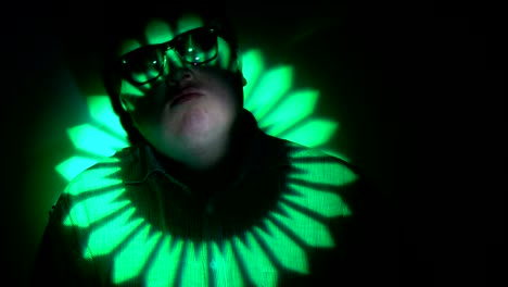 portrait of a fat man in a multicolored light beam.