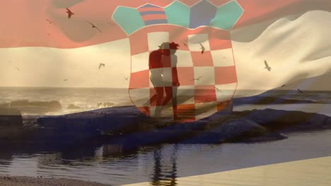 animation of flag of croatia over african american couple at beach