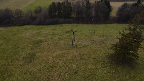 flying over a power line in the middle of a forest surrounded by trees