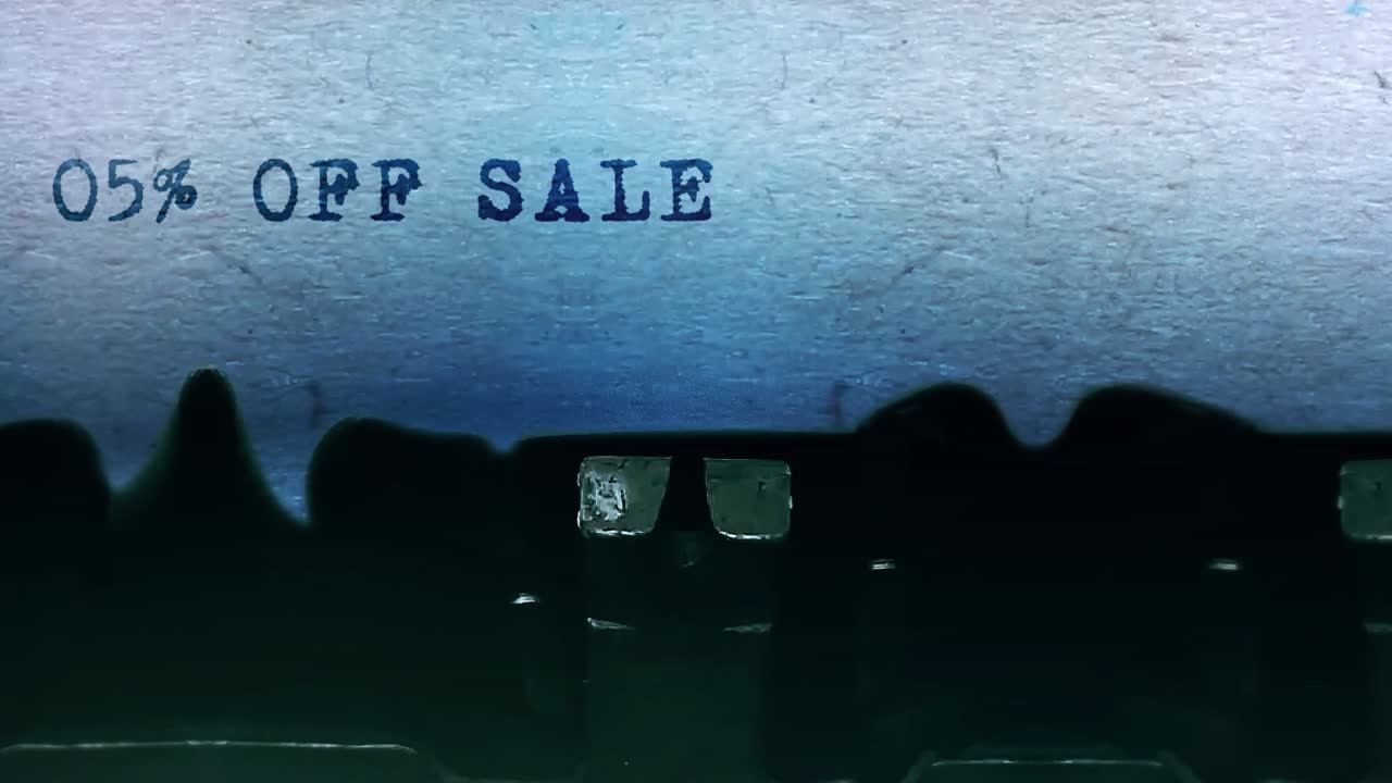 05 off sale word closeup being typing and centered on a sheet of paper on old vintage typewriter