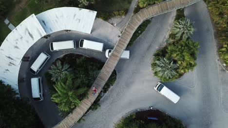 top view of white shuttle vans at the entrance of resort