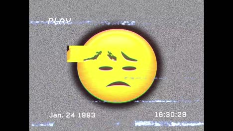Digital animation of vhs glitch effect over sad face emoji on black background