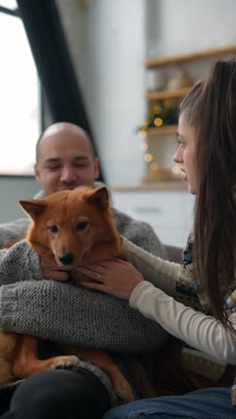 couple and dog relaxing at home