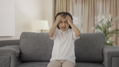 sick indian boy having a headache