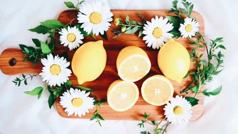 lemons and daisies on a wooden board