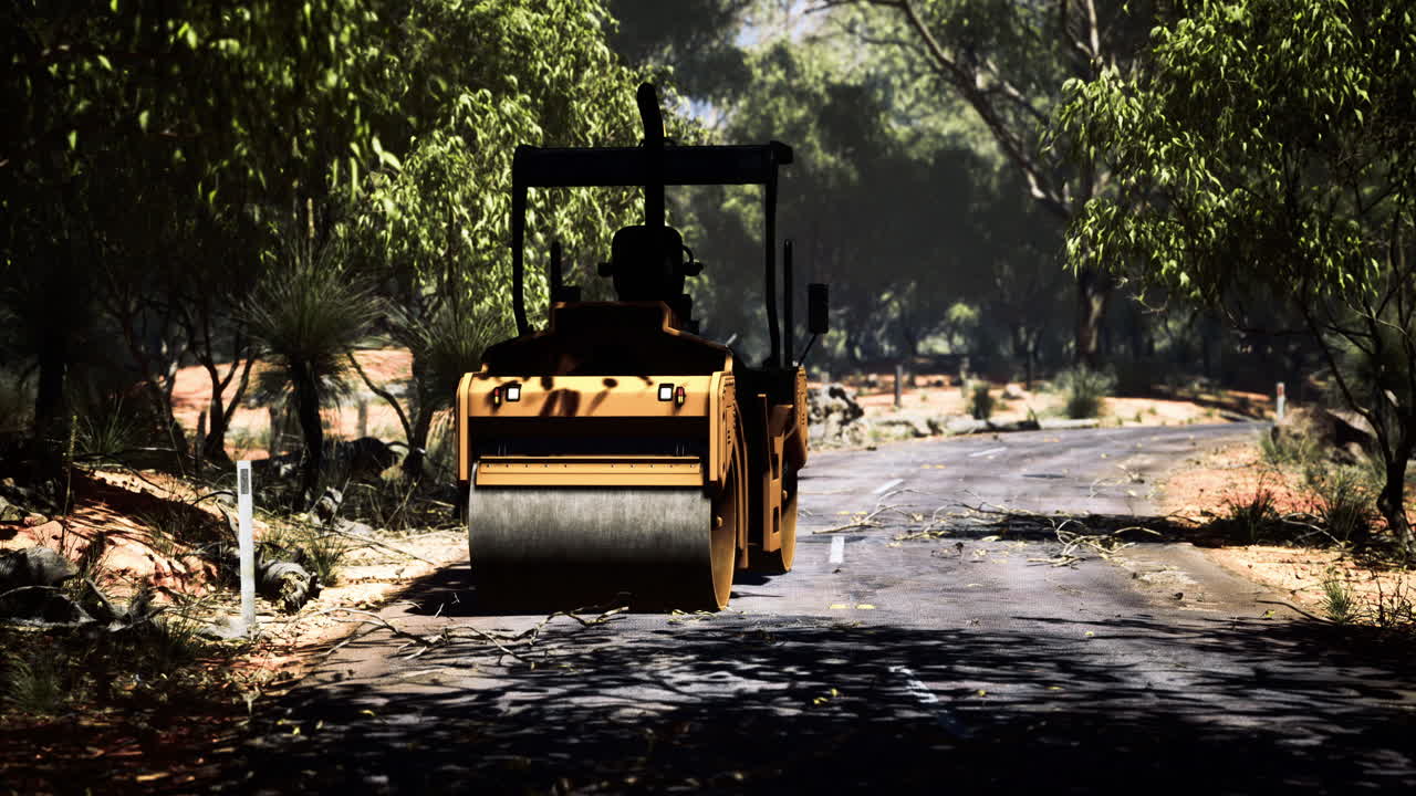 Construction equipment smooths a winding road through lush landscape
