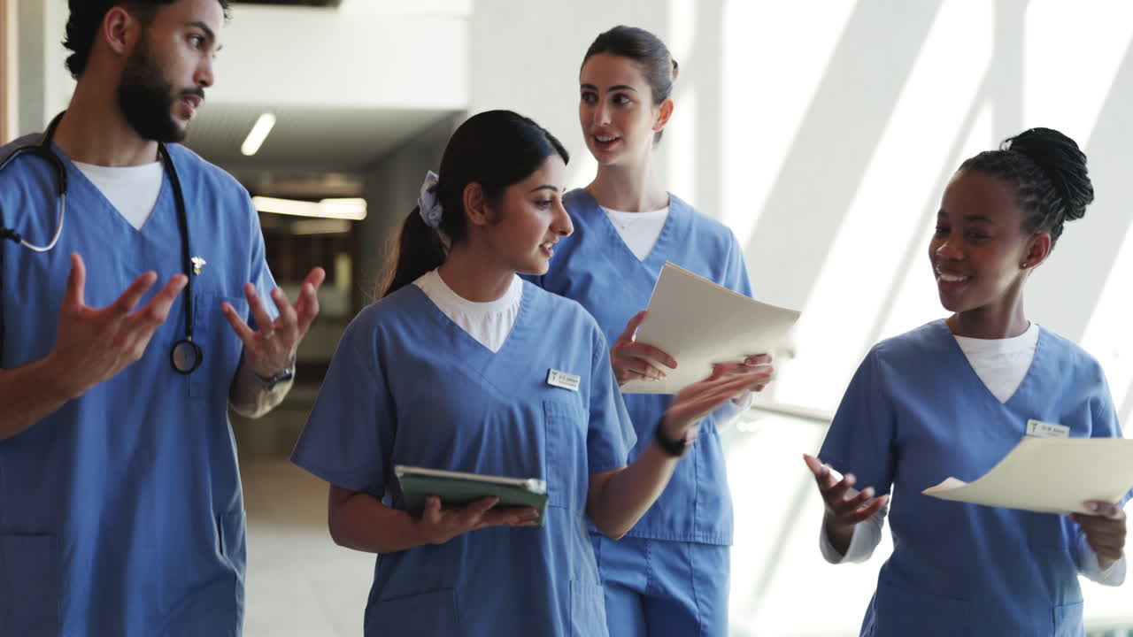 Diverse Medical Team Discussing Patient Care in Hospital Corridor
