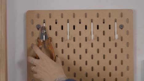 wall-mounted tool organizer with various tools