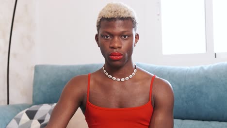 a person with blonde hair and red lipstick looking at the camera.