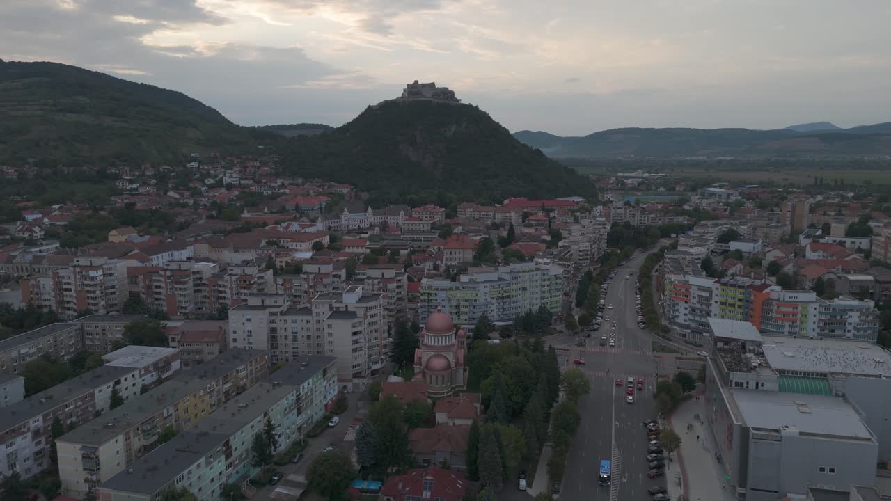 Smooth aerial descending approach to Deva’s Annunciation Orthodox Church, highlighting its domes and architectural details