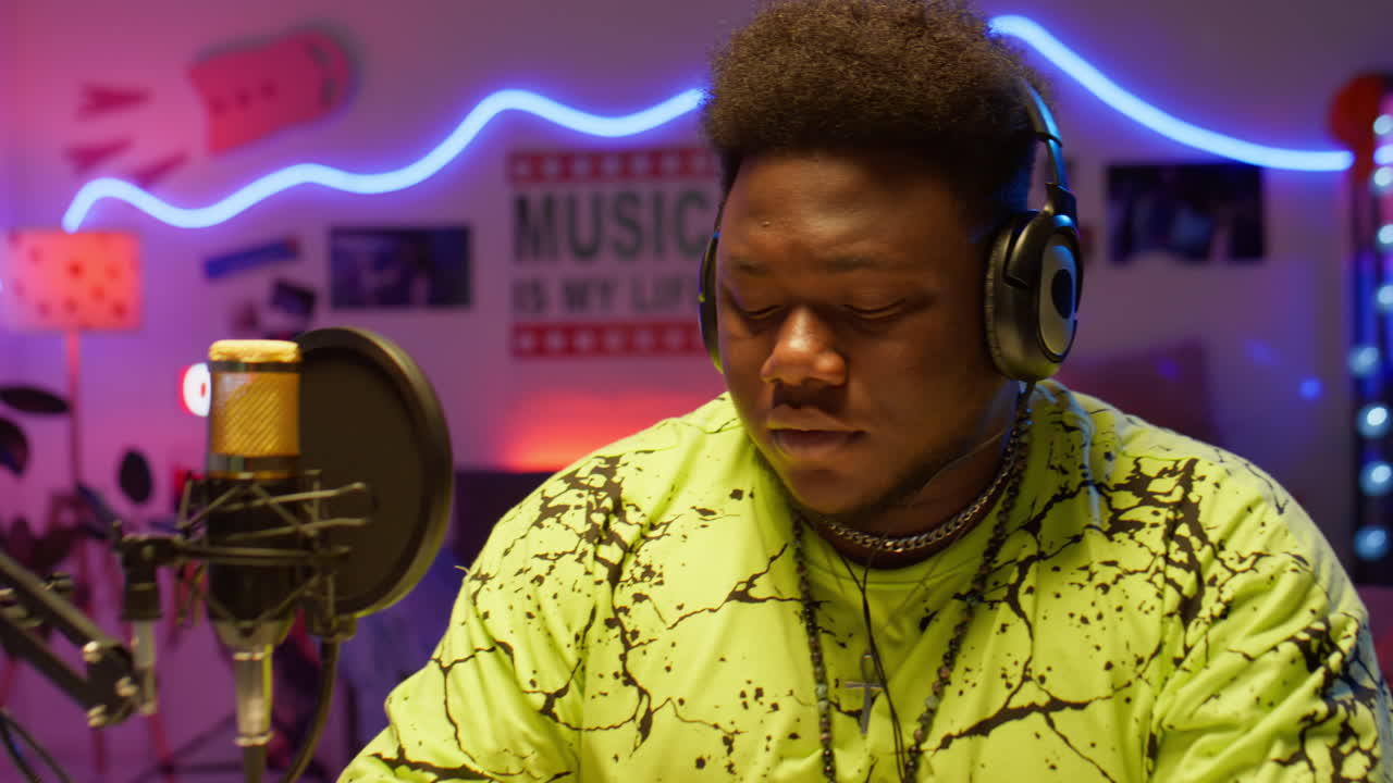 Black Musician Writing Song in Recording Studio