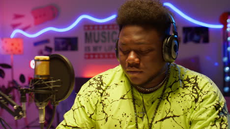 black musician writing song in recording studio