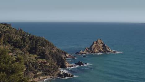 hidden lesser known beach on mediterranean coast of italy, sunny day pan