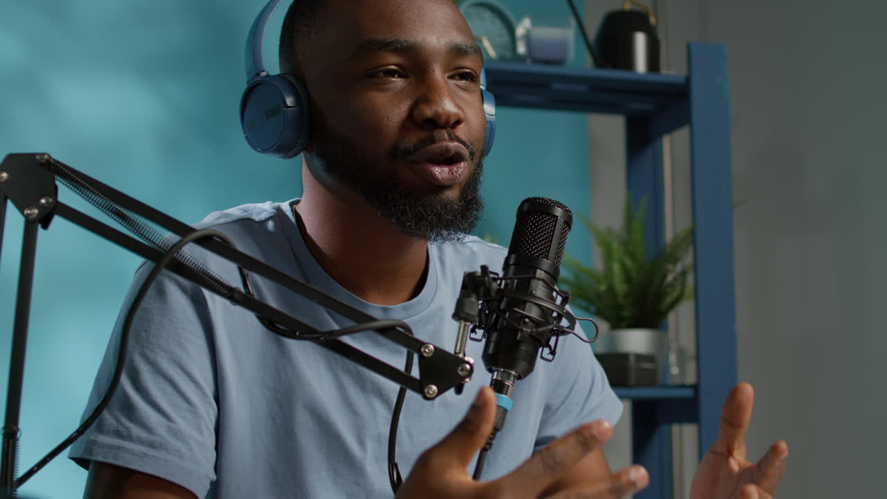 Close up of vlogger using microphone and headphones