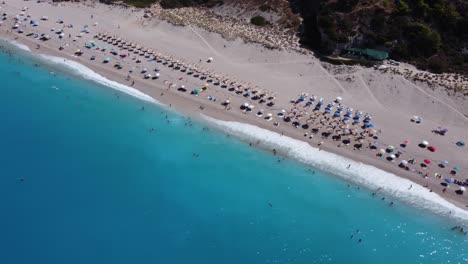 an aerial drone shot capturing milos beach on the greek island of lefkada. stunning sandy beach washed by crystal-clear water. d-log m