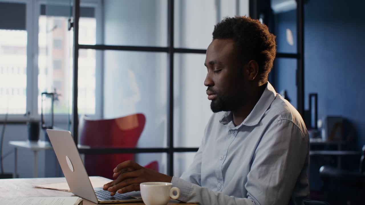 Man Working on Laptop in Modern Office