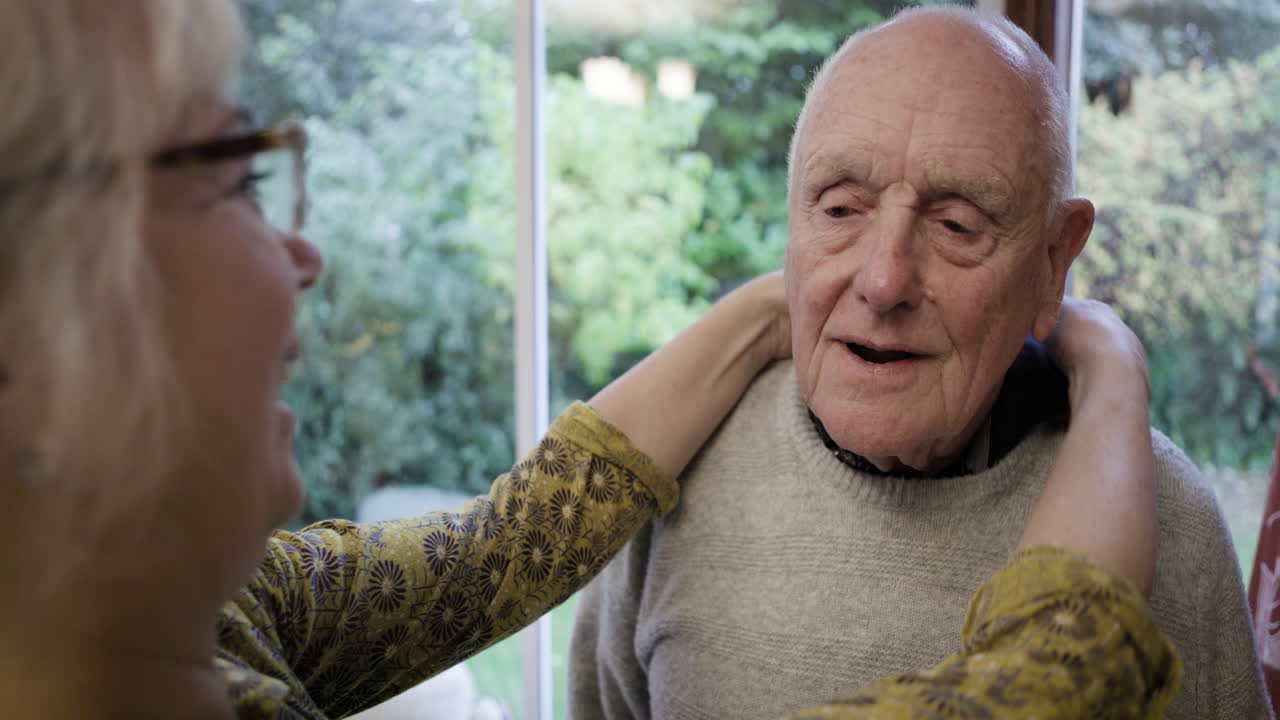Elderly Man Receiving Support from Caregiver
