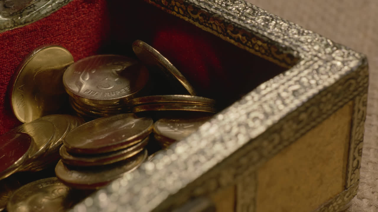 small treasure box opening and indian currency shining golden 5 rupees inside, 4k, stable shot