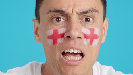 man with english national flag upset with a football referee