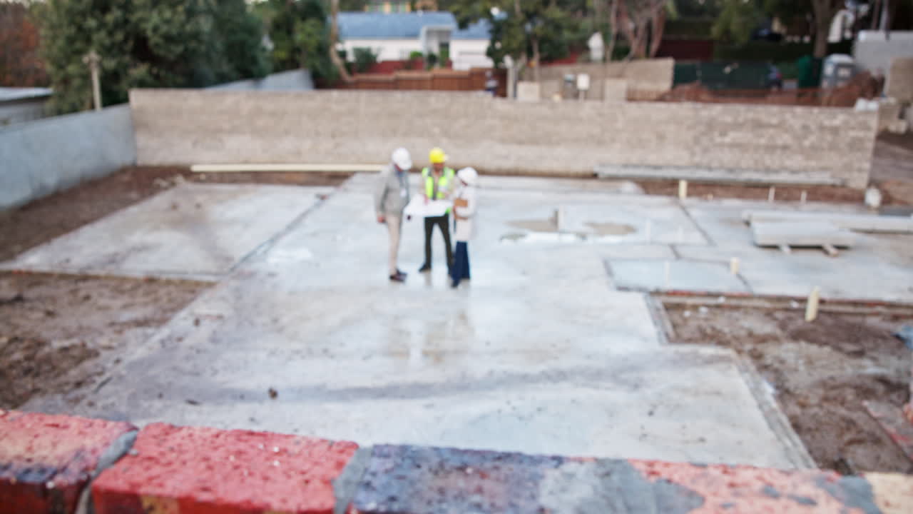 Construction workers on a building foundation