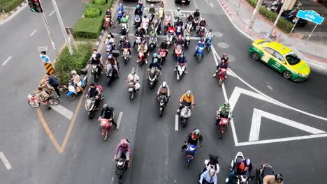 motorcycles and cars navigate through traffic