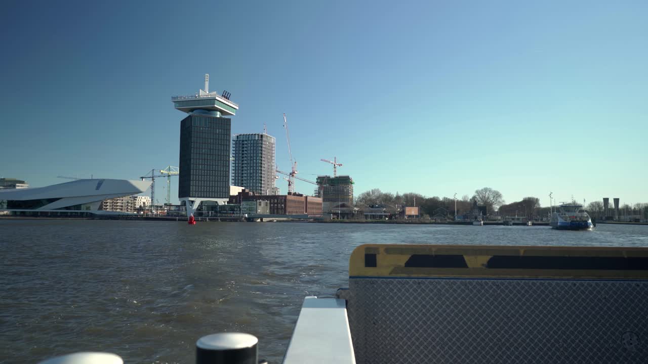 View of Eye Film Museum, A'dam lookout Tower during covid 19 pandemic lockdown from ferry across IJ river, Amsterdam, Overhoeks, 03-21-2020