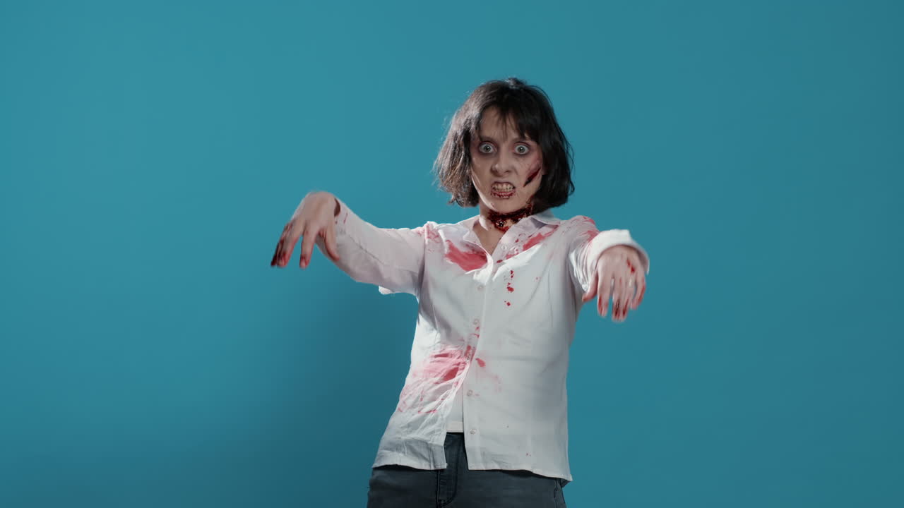Creepy zombie woman acting bizarre and sinister while growling on blue background