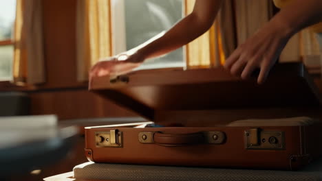 opening a vintage leather suitcase