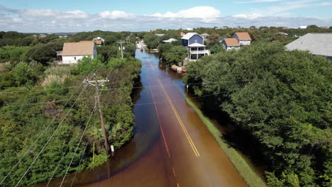 drone shot of cars and trucks driving through flooded roads