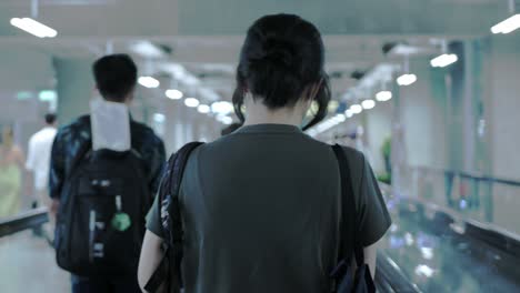 asian-woman-walking-in-airport-to-check-in