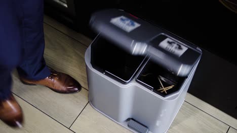 well dressed man throwing garbage into the segregated garbage container in office in 4k