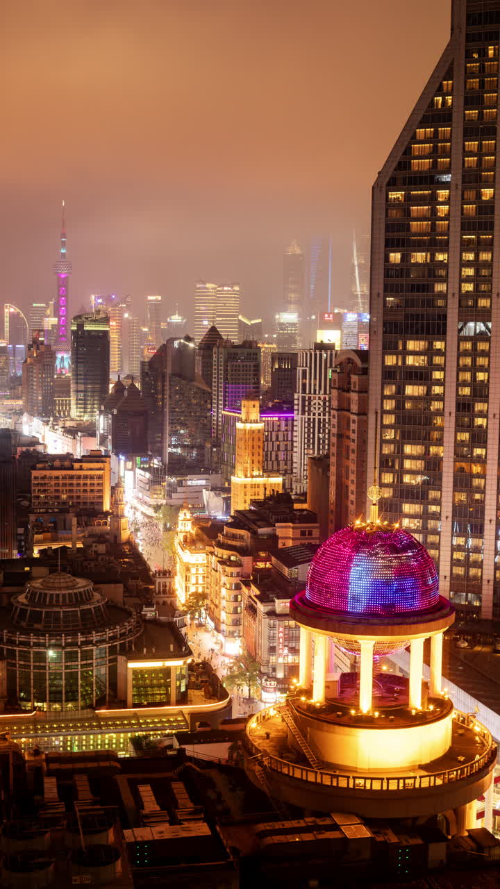 SHANGHAI, CHINA - 18 MAY 2025 : Timelapse of the Shanghai city skyline from a high vantage point at night in vertical