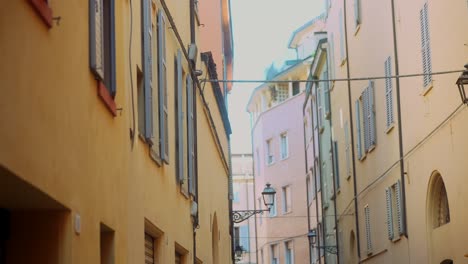 narrow italian street with pastel-colored buildings