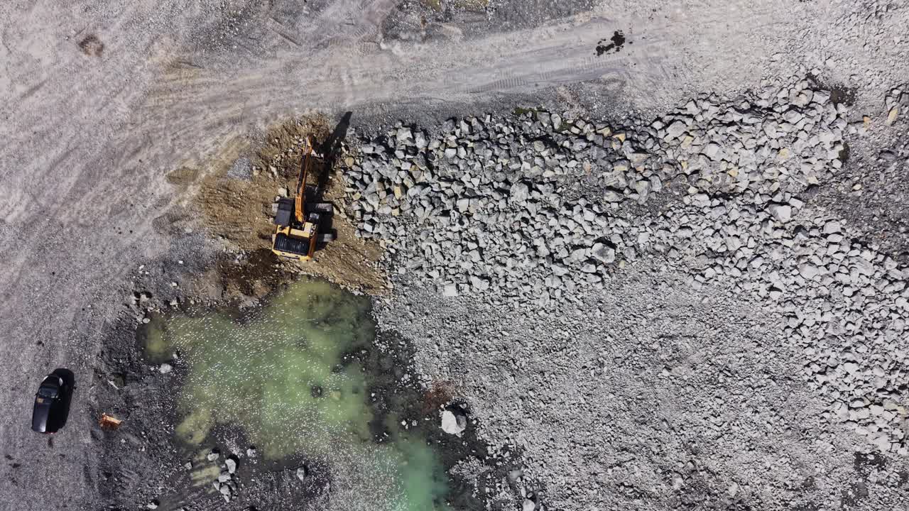 Aerial View of Excavator Digging in a Quarry