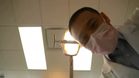 male dentist examining a patient with tools 4k