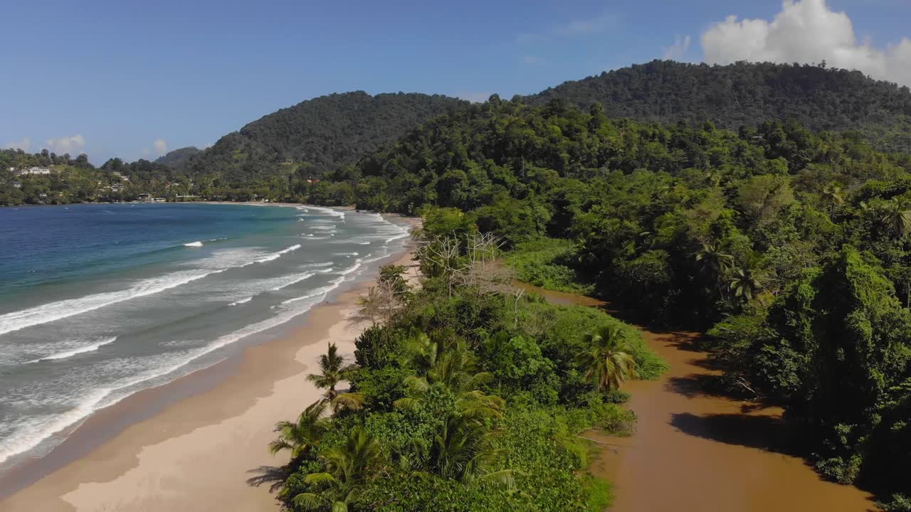 Descending aerial of an epic north coast locating of the river meeting the sea on the Caribbean island of Trinidad and Tobago