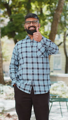 Happy-Indian-man-shows-thumbs-up-like-sign-positive-something-good-positive-feedback-in-city-street