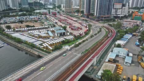 top view over mtr light rail as it crosses bridge, tuen mun, hong kong