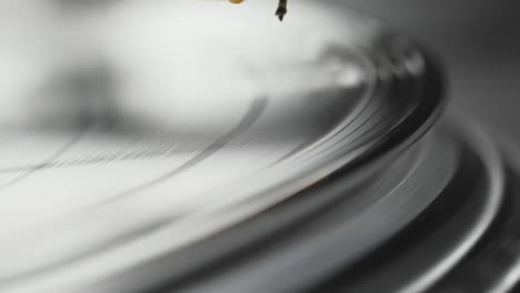 vinyl player turntable. a fragment of a rotating vinyl record, a stylus with a needle close-up. stopping a needle and a vinyl plate close-up. macro. view from above