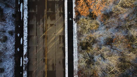 aerial shot of mount sequoyah, ar with a wide street and autumn trees, sunlight casting shadows