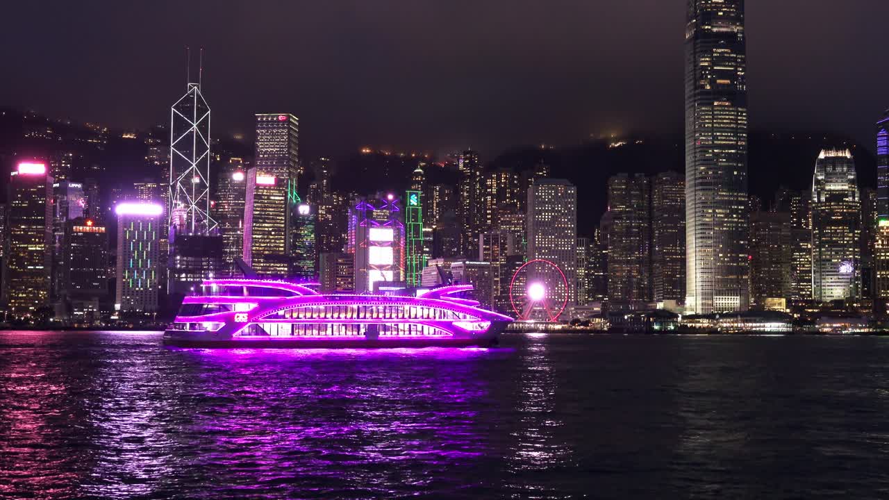 Ferry with Purple Neon Sailing in Victoria Harbour in Hong Kong at night